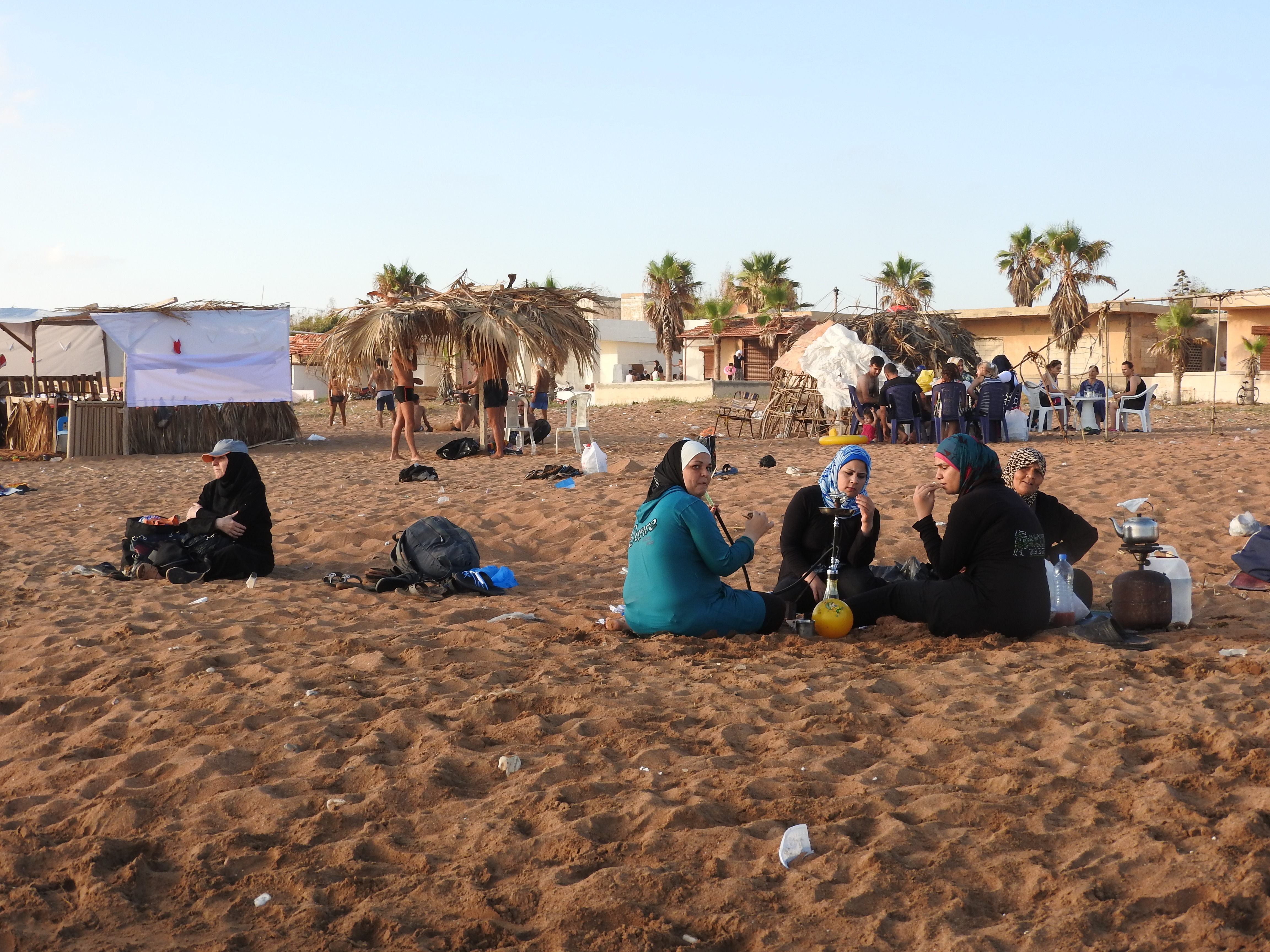 In 2016, I visited Tartous, to see the transportation terminal which was attacked by Western-backed terrorists on May 23rd, the same morning a transport hub (and street and hospital) in Jableh (which I also visited) was attacked. Tartous houses 1 million internally-displaced from all over Syria, including people from Deir ez-Zor, Raqqa, Aleppo, Homs, and elsewhere, according to the Governor of Aleppo (as of mid-2016), who said the city is known as "mini-Syria" in recent years due to its hosting of Syrians from all over. "The 1 million IDPs share Tartous' resources, schools, and hospitals with 1 million inhabitants." They are not housed in tents and camps, but in schools/other buildings-turned refugee centres, as well as houses. I visited one of these centres while in Tartous, also visiting centres in Latakia, Aleppo, Damascus over the past few years. While in Tartous I saw an endless sea of posters of martyred soldiers, billboards listing their names, to give respect to their defense of Syria. I was also treated with an unplanned visit to the sea, where I saw normal beach scenes, and more: Syrians of varying ages and faiths, living, loving, resisting the war of terror on their country. While there, my host made sure to note: "Do not think these people haven't suffered.There isn't a house here that hasn't lost a family member or relative," she said of Syria's fight against terrorism and for the restoration of peace and security. Videos here: https://www.facebook.com/EvaBoBeeva/posts/1611030225573632