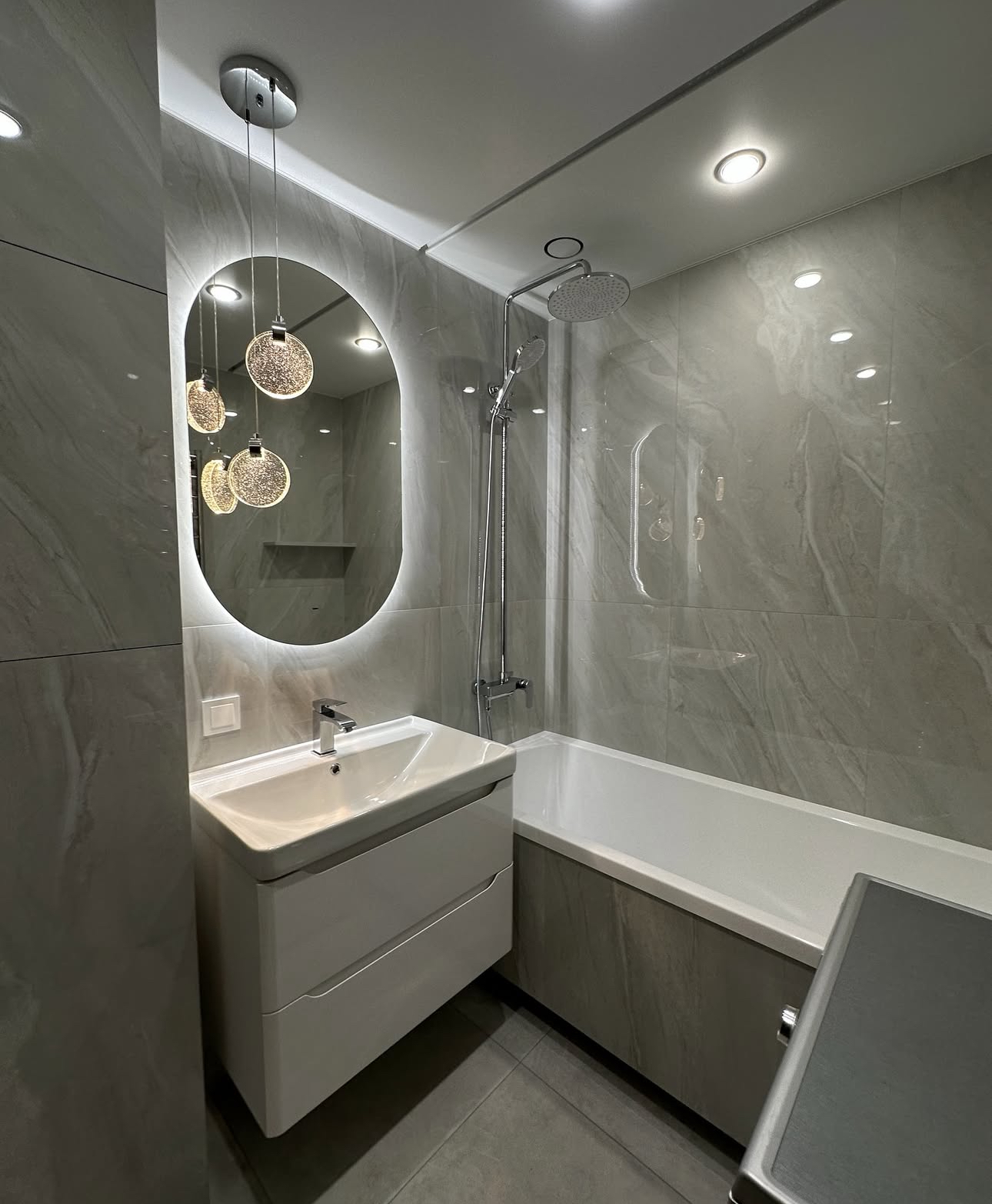 Luxury bathroom renovation in Manhattan with double vanity, soaking tub and marble finishes