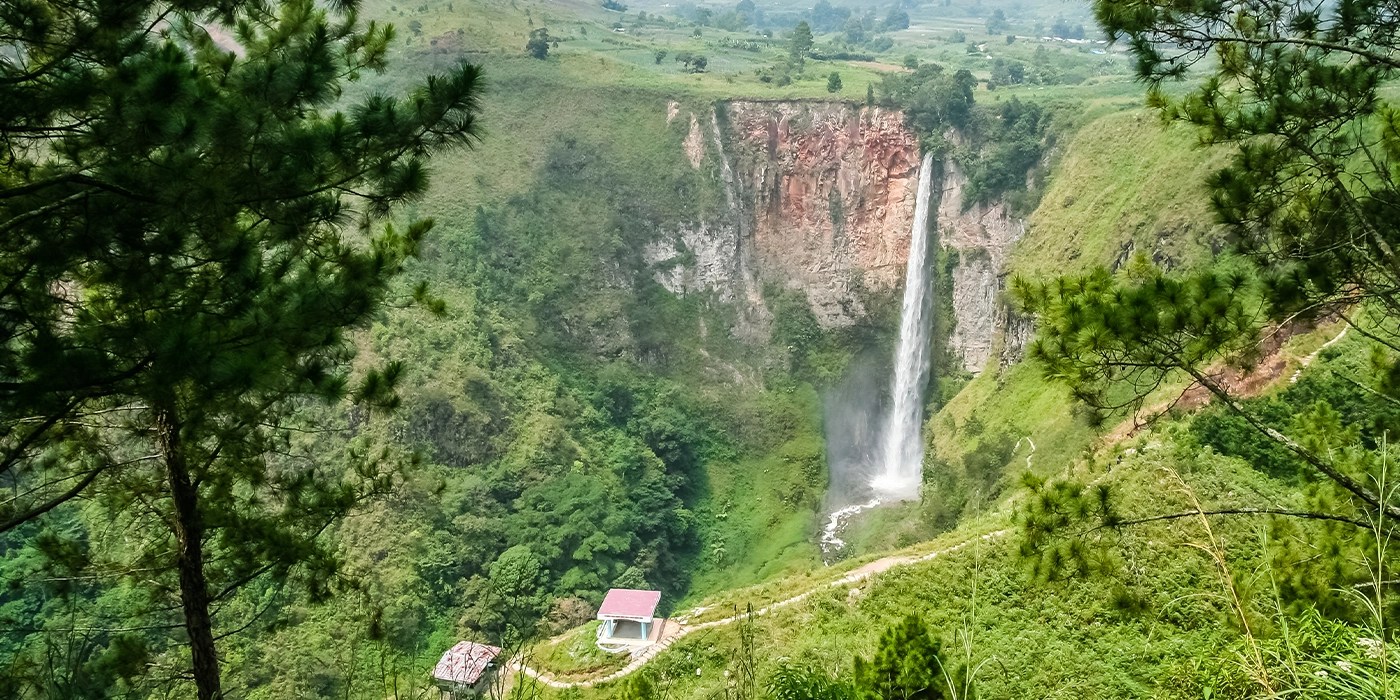 Sipiso-piso Waterfall surrounded by lush rainforest in North Sumatra