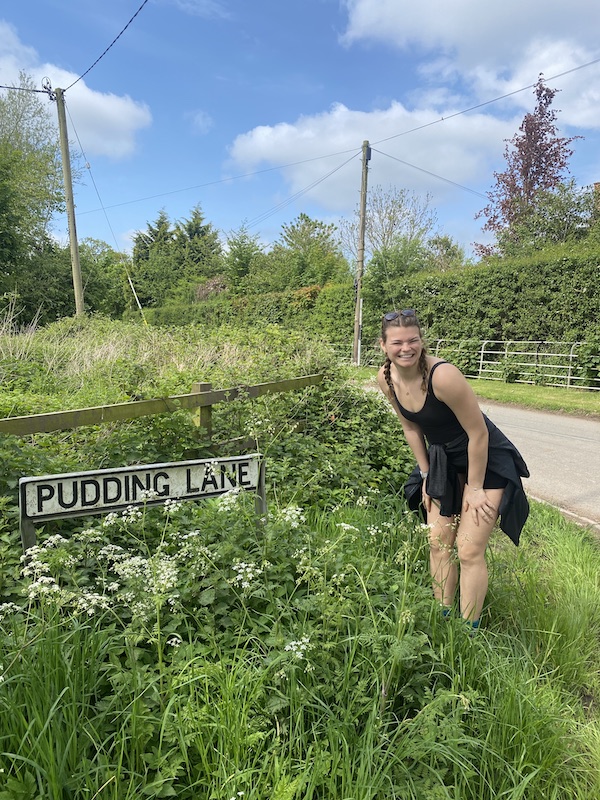 Lou posing next to a street sign ("Pudding Lane")