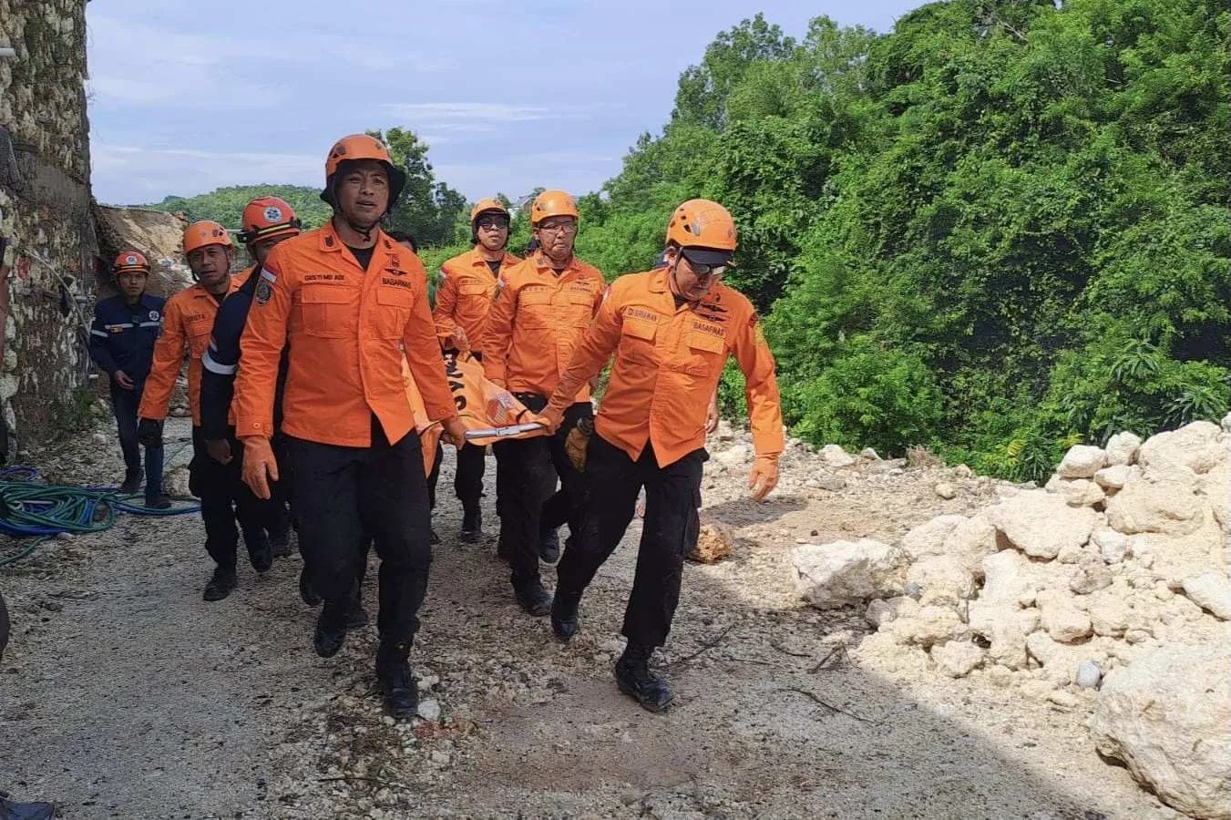 Tim SAR gabungan melakukan evakuasi korban tertimbun longsor di Ungasan menggunakan alat berat.