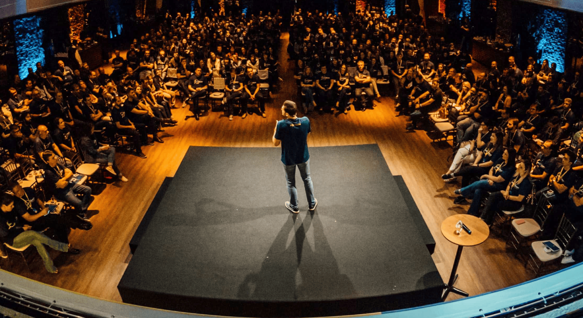 Keynote speaker addressing large seated audience