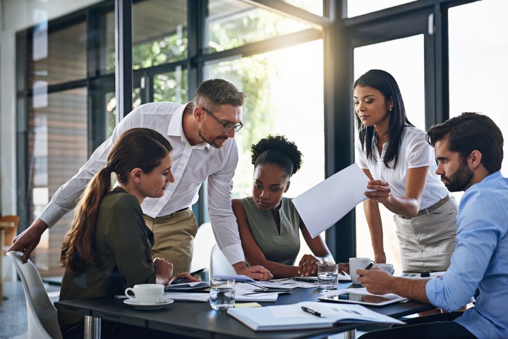 Business team collaborating around conference table
