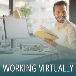 Smiling man working virtually at computer