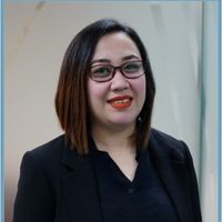 Smiling woman wearing glasses and black blazer