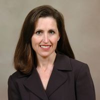 Smiling professional woman wearing dark blazer