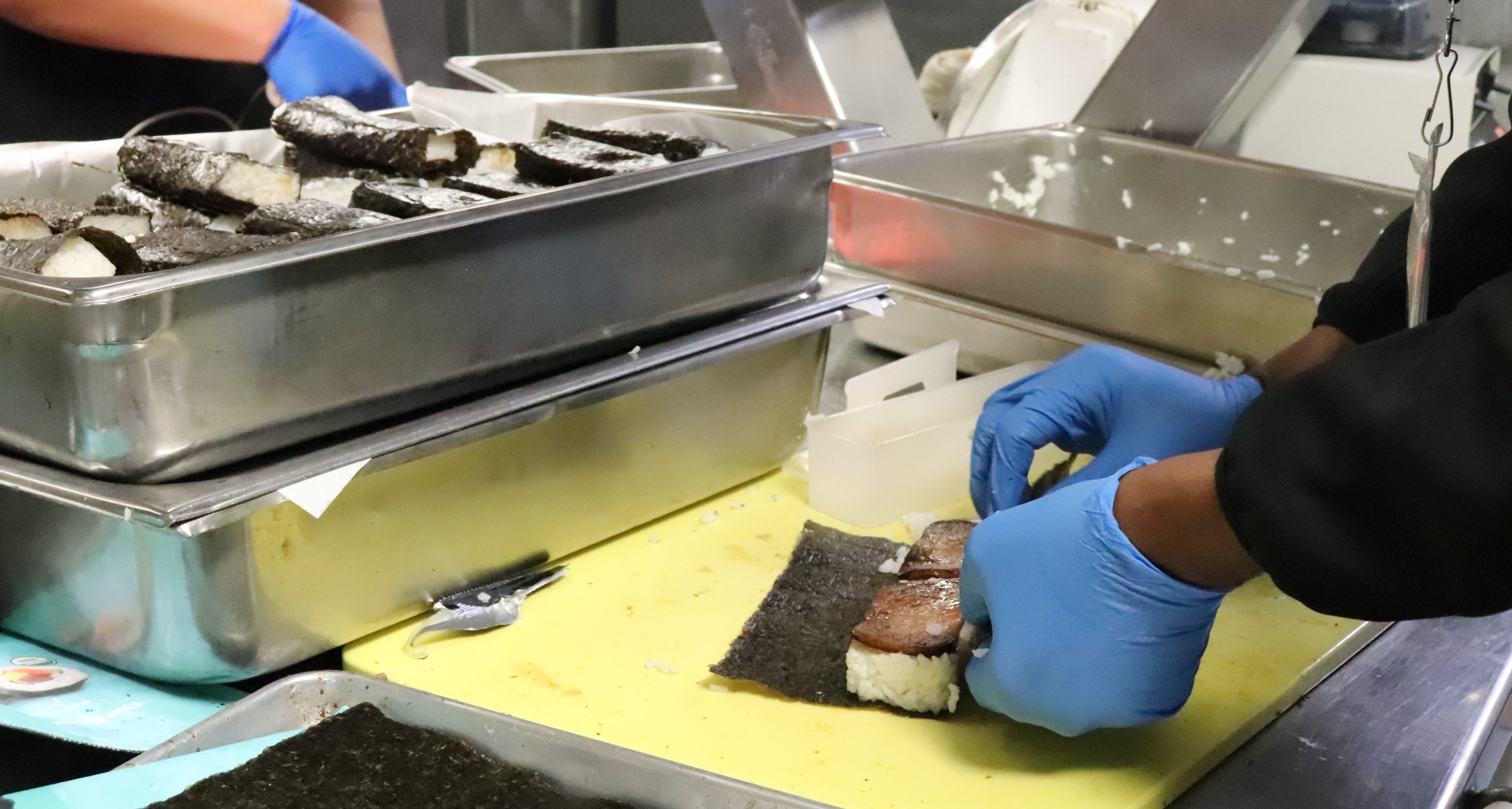 close up of hands cooking food in a kitchen