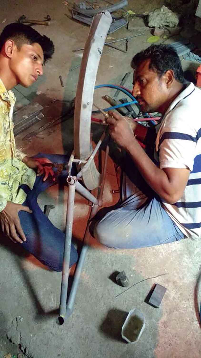 Restoration process of the cycle with Anisbhai and his son at work late into the night