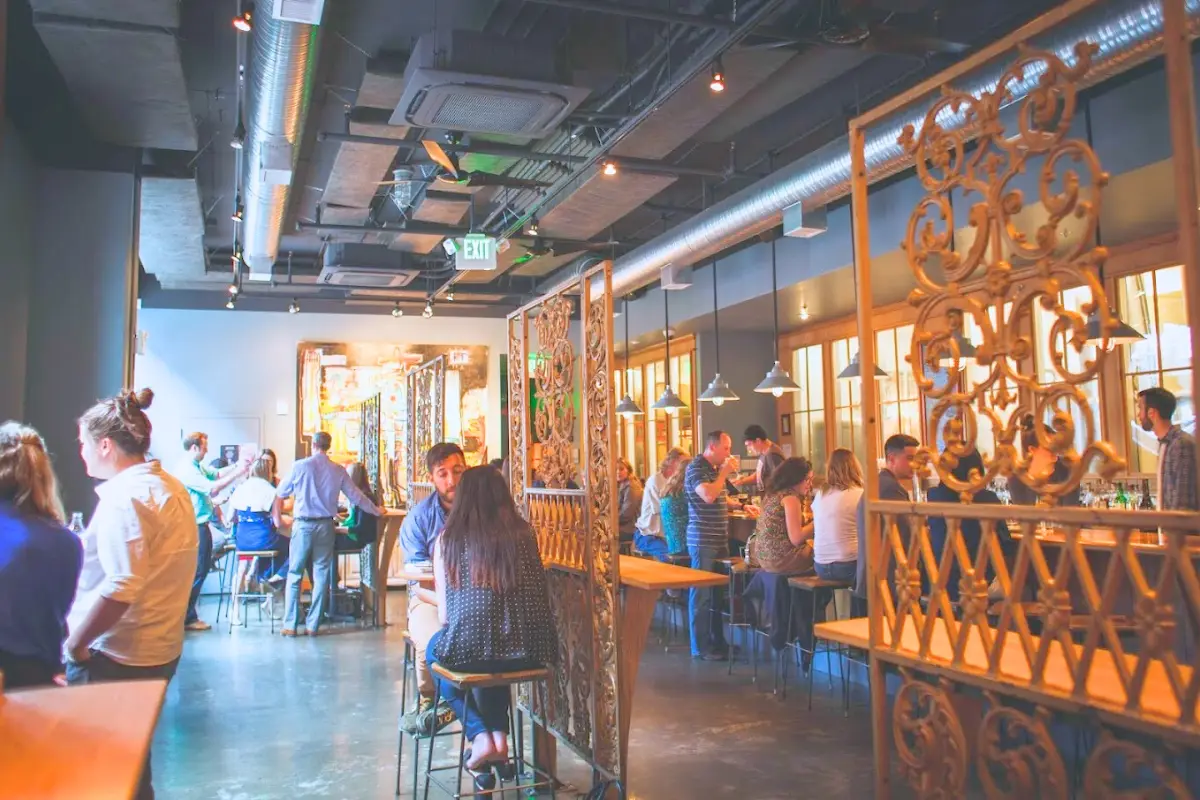 An inviting indoor space with industrial design with people sitting and hanging out