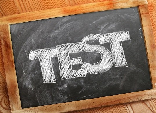 A name "TEST" written on a dark background on a board