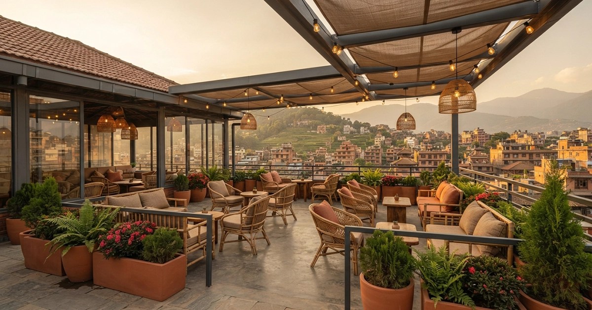 Stunning rooftop cafe interior design in Nepal featuring wooden furniture, ambient pendant lighting, and Kathmandu skyline views.