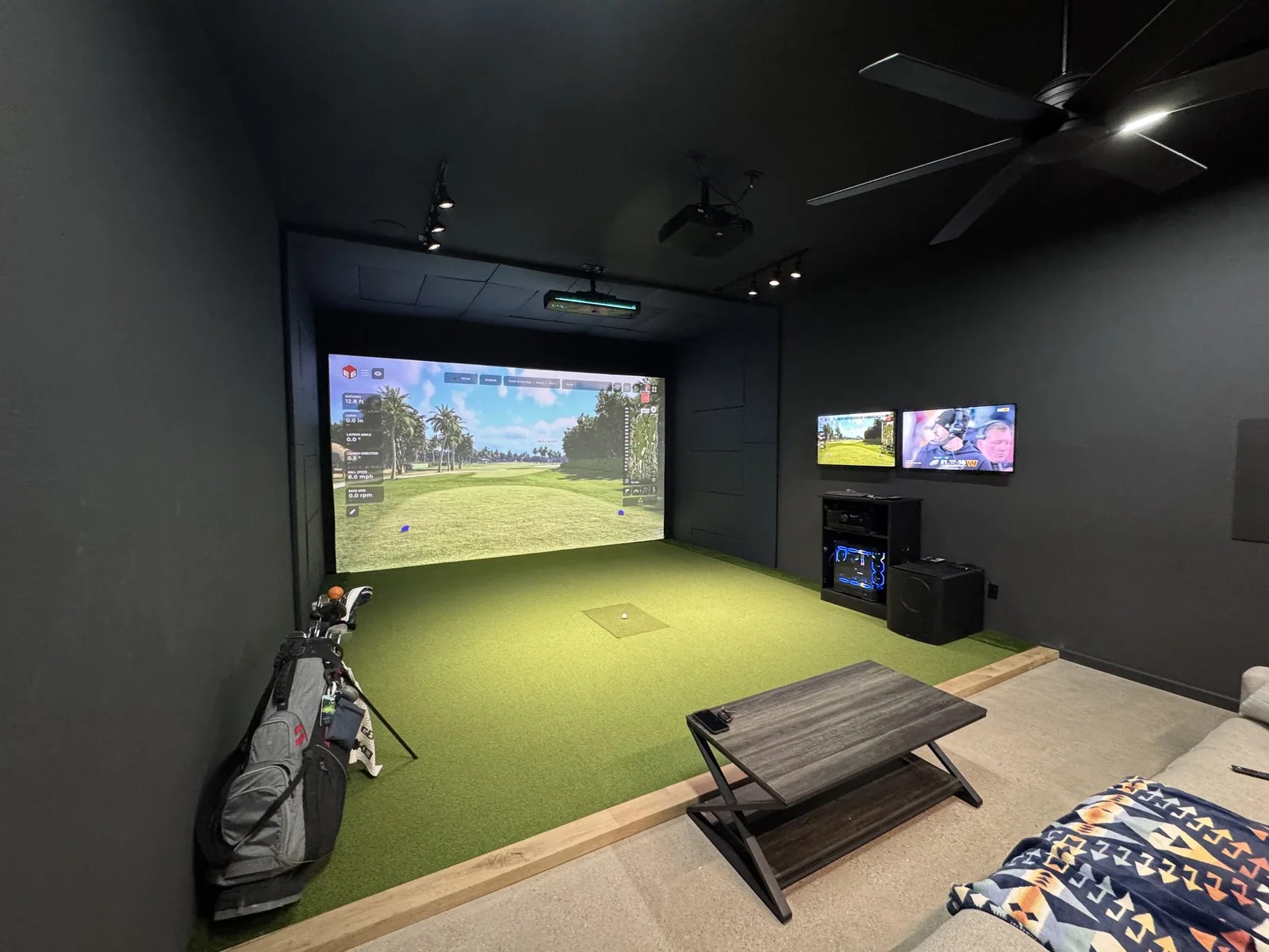 Custom home simulator with turf floor and dual screens