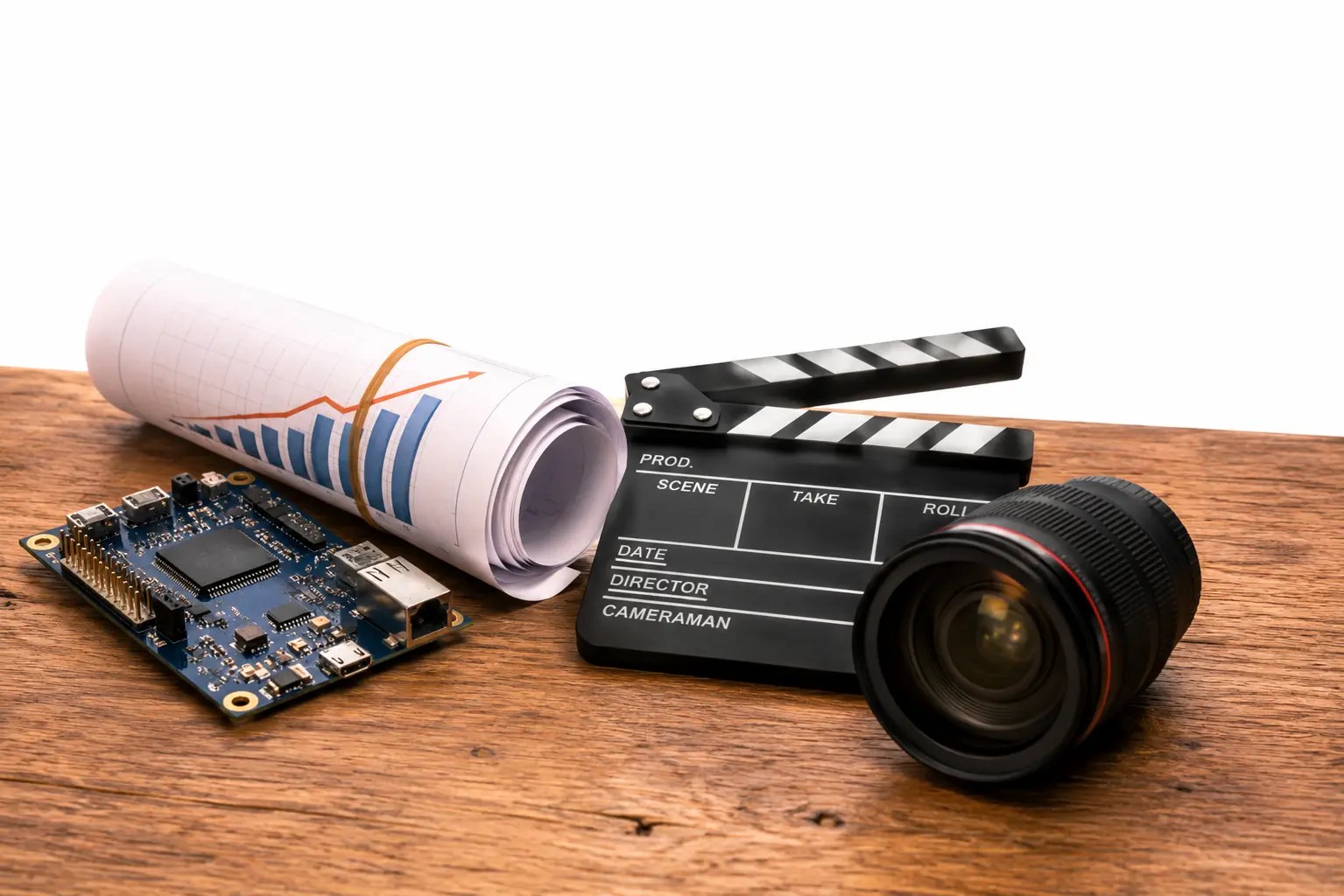 Partner-led services circuit board, growth chart, and film clapperboard representing embedded systems, marketing, and media