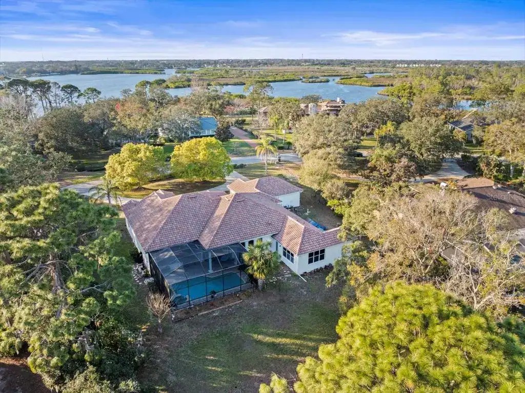 Spacious suburban home with lush greenery, large backyard, and waterfront views, perfect for outdoor living and relaxation. Beautiful neighborhood with scenic lakes and mature trees.