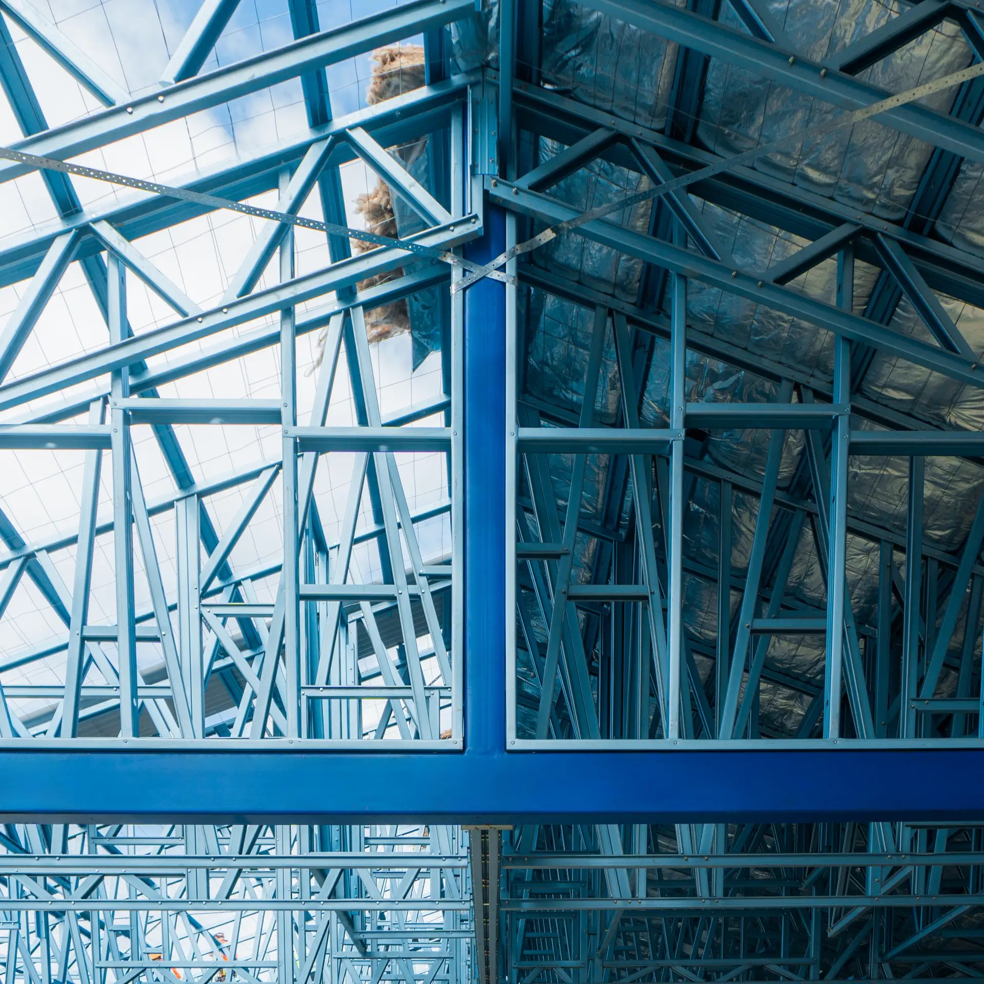 Structural steel posts supporting a high-load framing system in large-scale construction