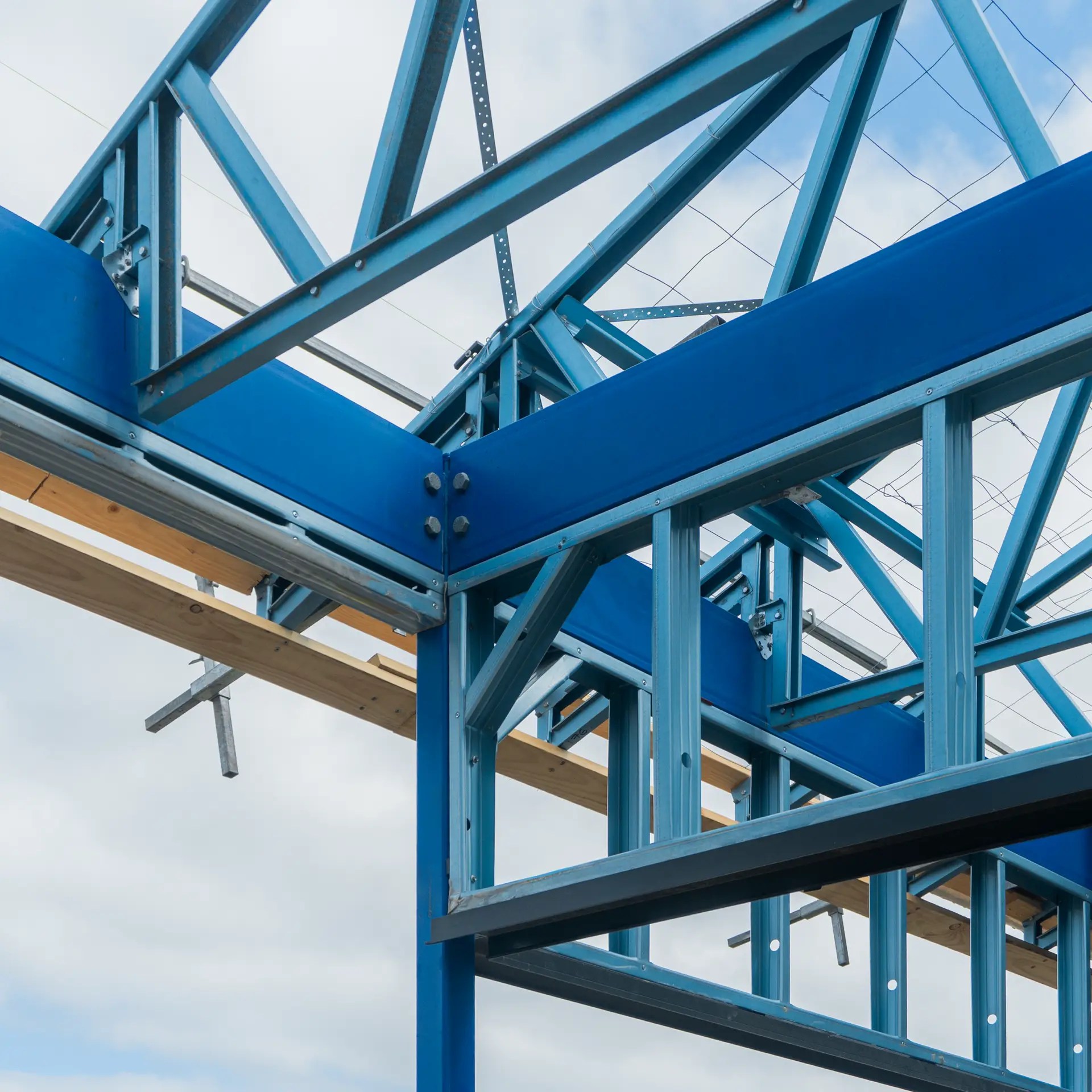 Steel beams installation in a commercial framing structure with cross-bracing