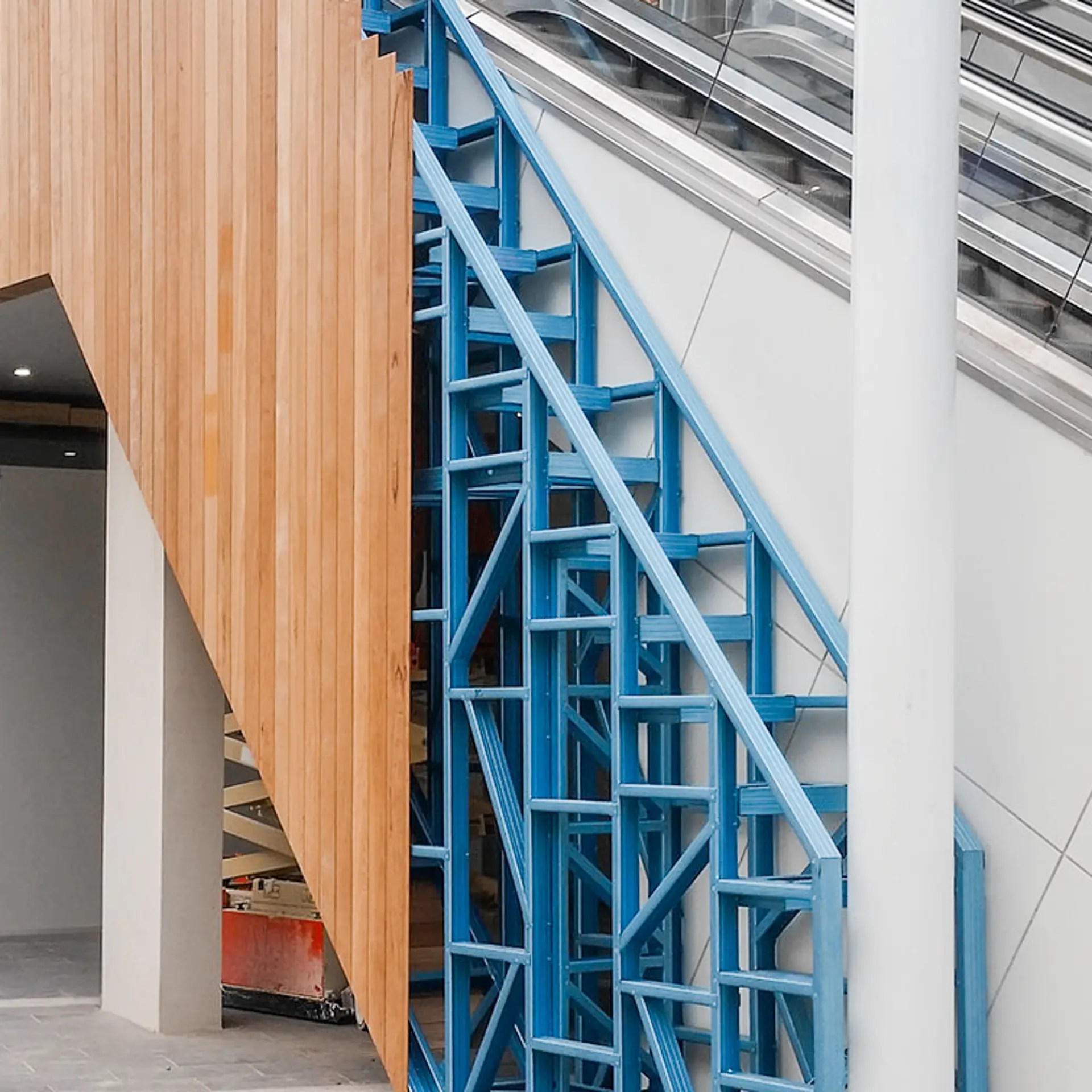 Blue modular steel framing integrated into a commercial staircase