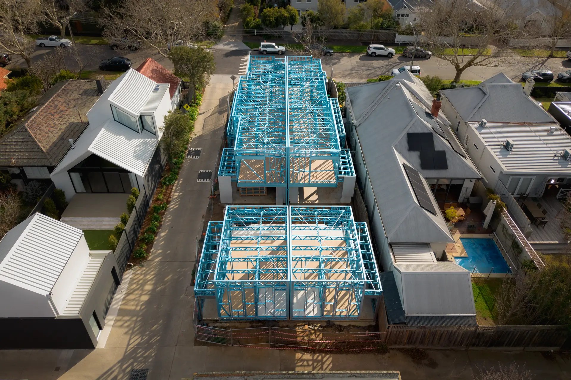 Top-down aerial shot of blue steel-framed residential structures under construction on Cressy Street, Malvern.