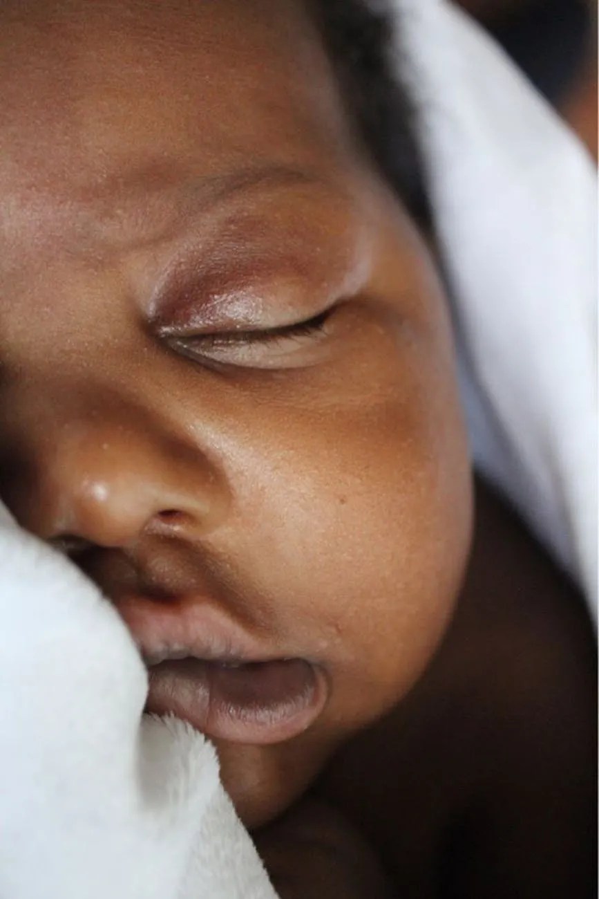 close up photo of baby s face