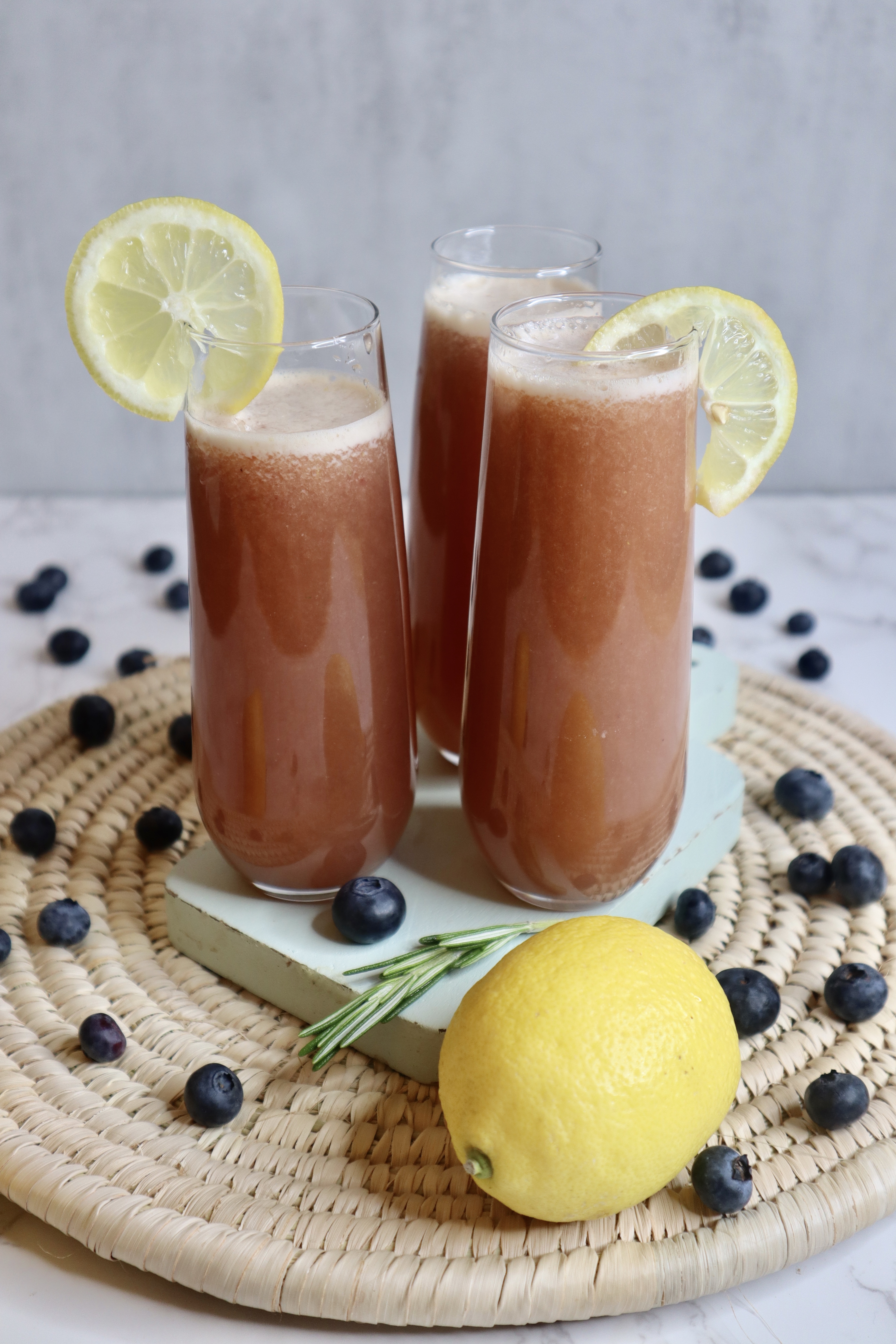 3 glasses of blueberry lemonade with lemon slice