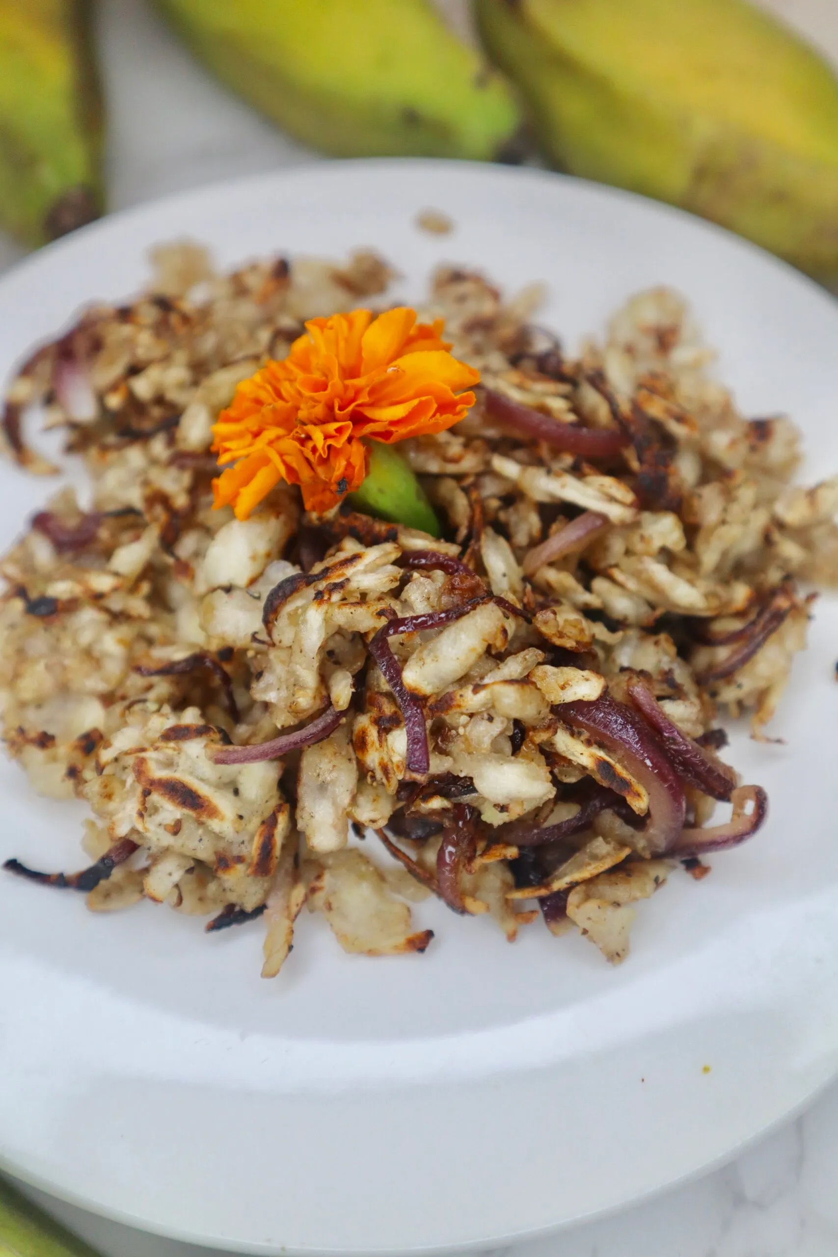 green banana hash brown with orange flower on top