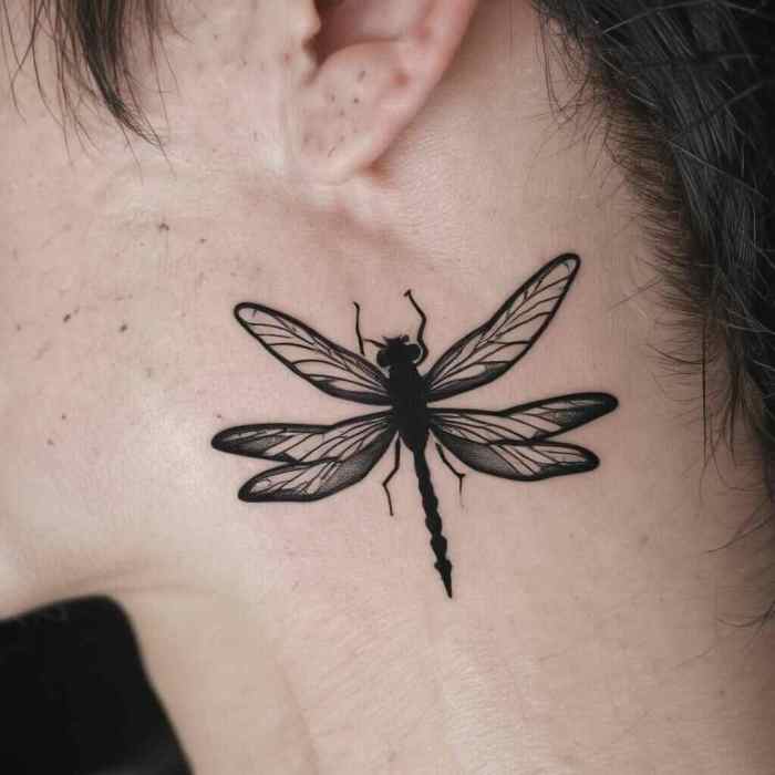 Minimal Dragonfly Silhouette Behind the Ear tattoo