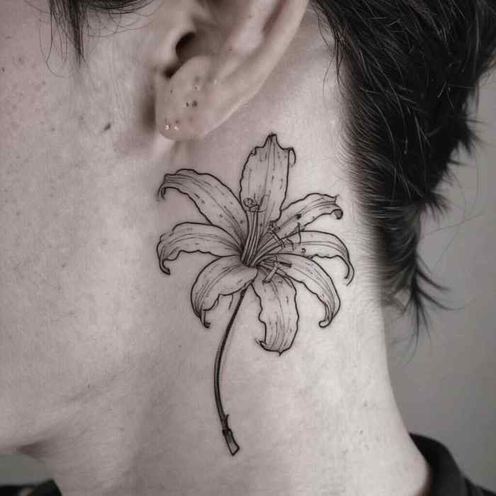 Simplistic Spider Lily Outline Behind the Ear tattoo