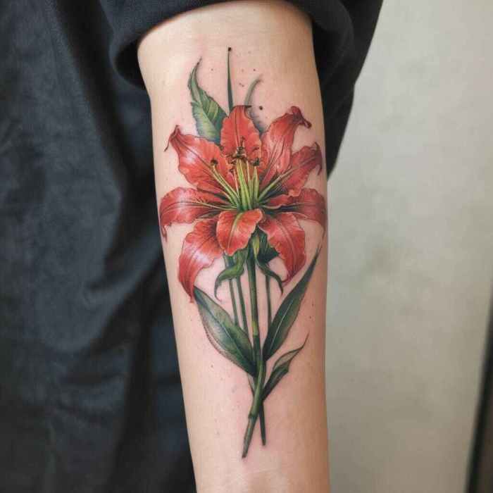 Vibrant Red Spider Lily with Green Stem on the Forearm Tattoo