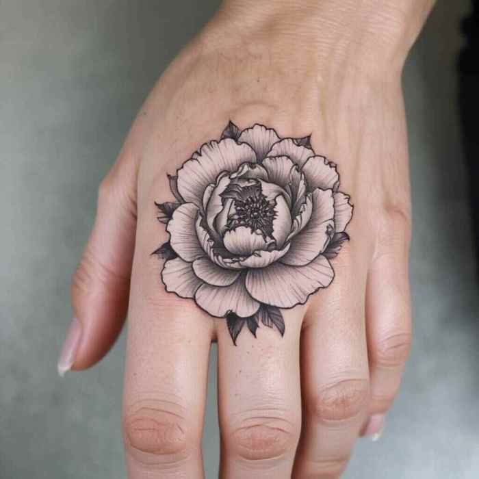 Minimalist Peony on the Finger with Delicate Shading tattoo