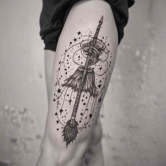 Simple Line Art Broomstick with Stars Trailing Behind tattoo