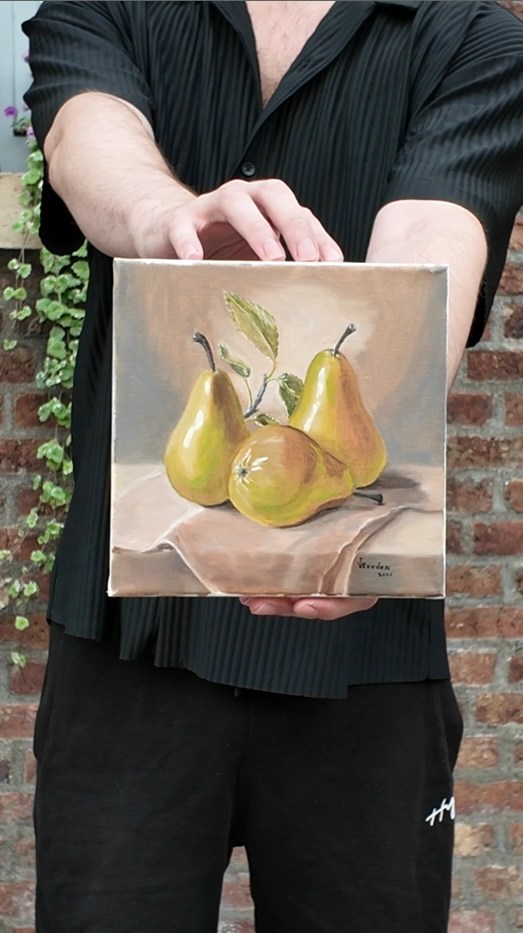 Still Life with Pears by JVRooden, shown being held by the artist to display the scale of the original oil painting.