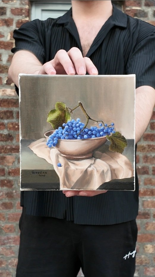 Still Life with Grapes by JVRooden, shown being held to display the scale of the original oil painting.