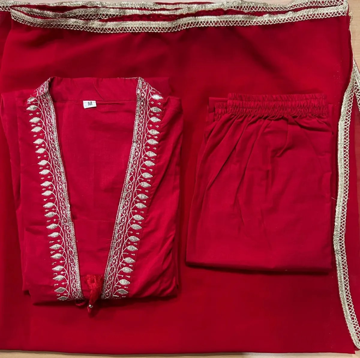 Red Anarkali suit set showing neckline and embroidery