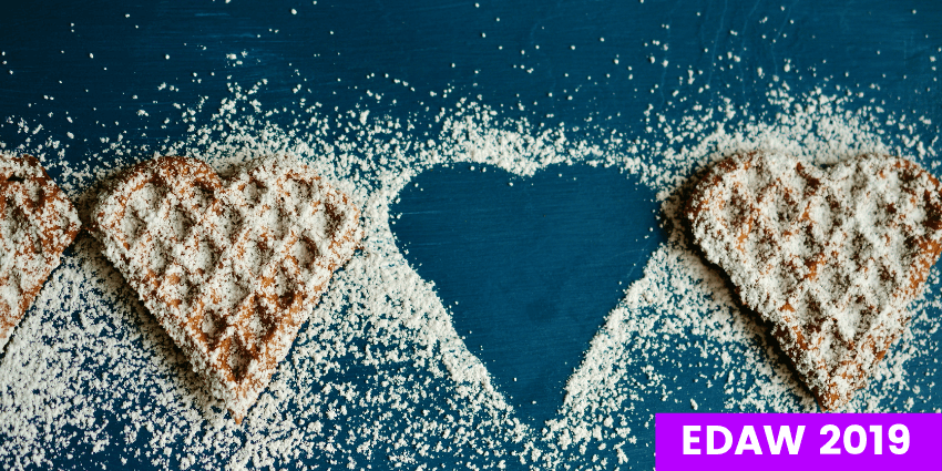 2 Heart Shaped Cookies with One Absent leaving a heart shaped cutout outlined with sugar.