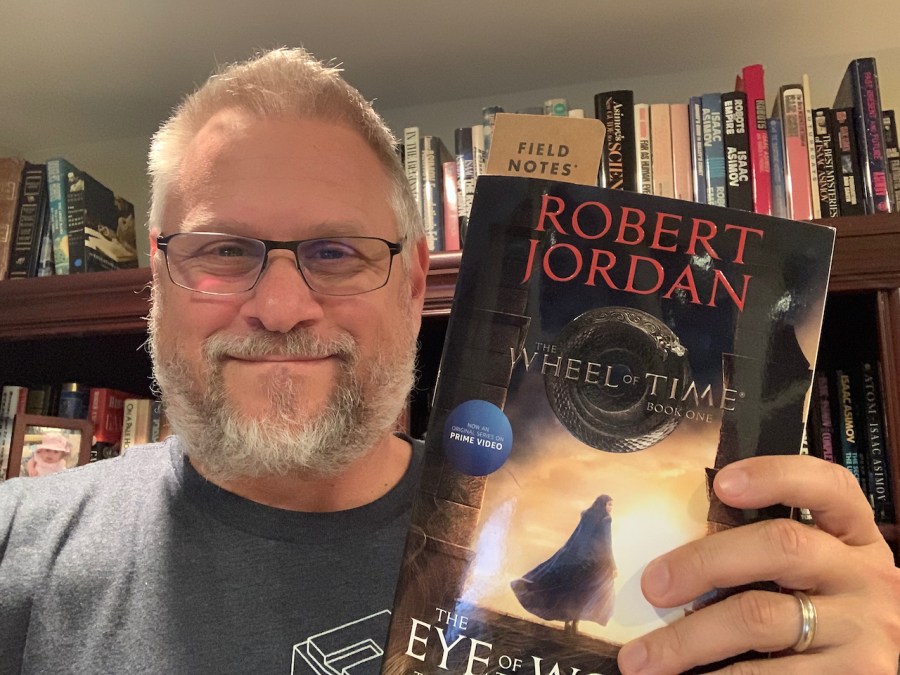 me holding a copy of wheel of time