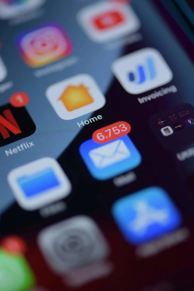 A smartphone screen cluttered with various notifications and alert icons, highlighting the overwhelming nature of constant connectivity.