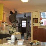 Tore off more paneling and exposed some more older walls. Found an unexpected hole in the wall. Uh-oh (3/19)