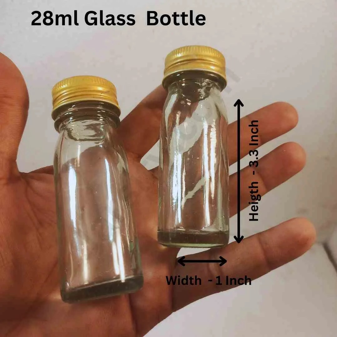 A tall and narrow transparent glass bottle is standing vertically on a country-style table.