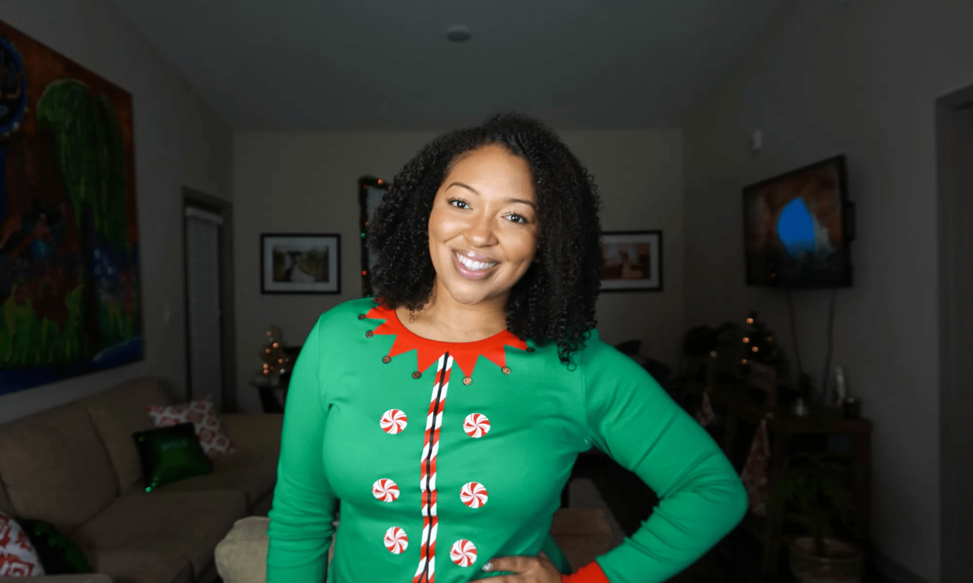 person with green shirt smiling at camera