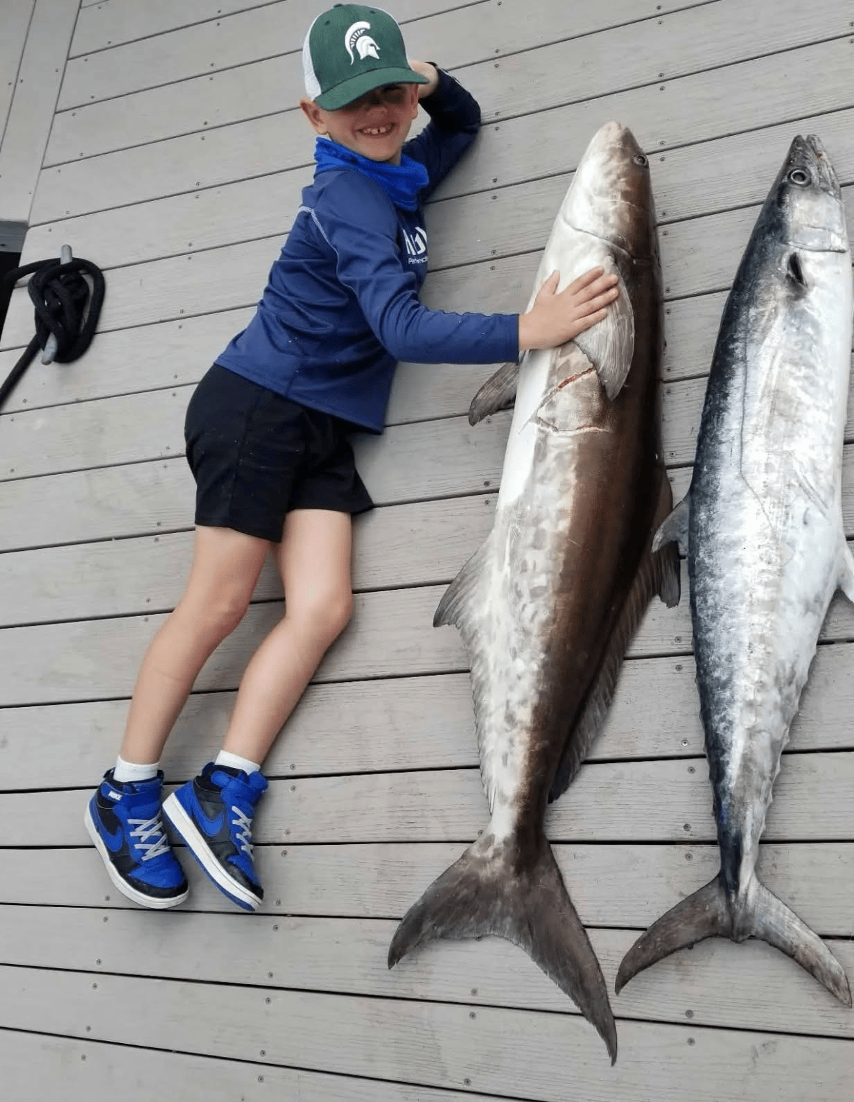 Young angler with offshore catch on a Jawstoo fishing charter