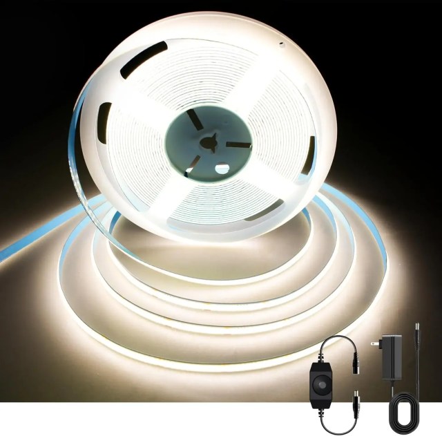 LED strip lighting installed on ceiling molding in a hallway with no natural light.


