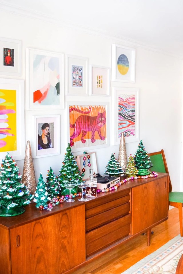 Mid century modern sideboard with a collection of green vintage ,ceramic trees with a couple of more modern metallic ceramic christmas trees.