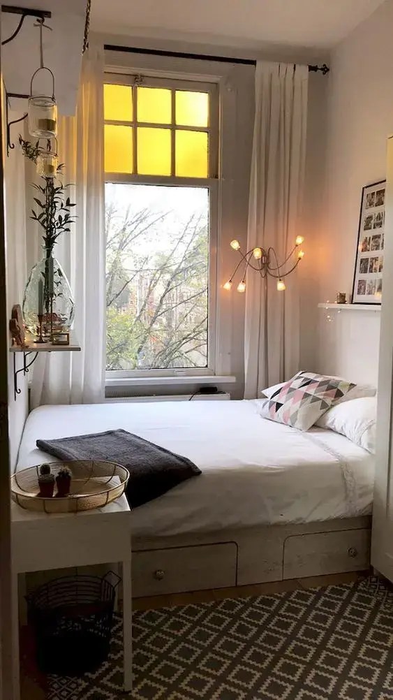 modern multidirectional floor lamp between the bed and the window
