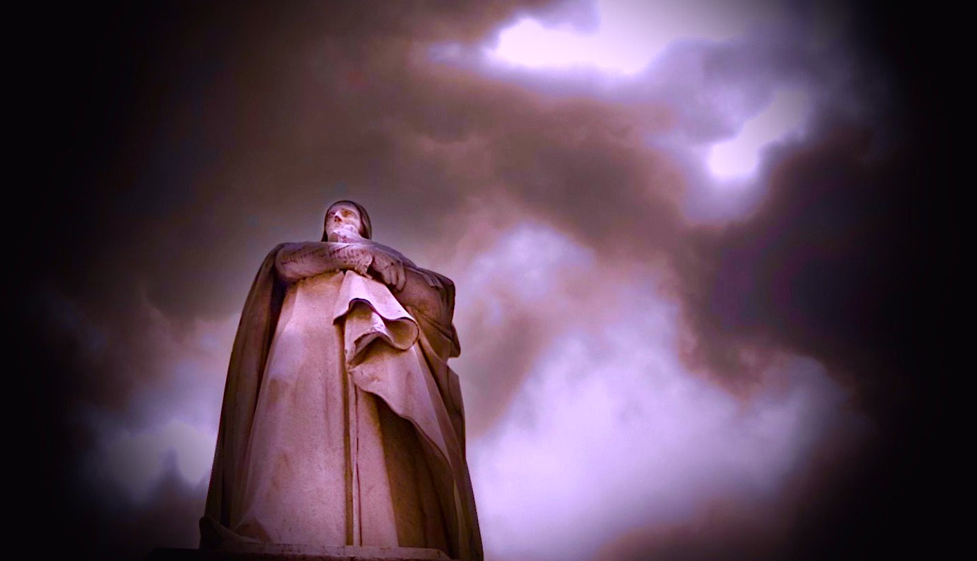 Moody image of the statue of Dante in the Piazza dei Signori Verona Italy