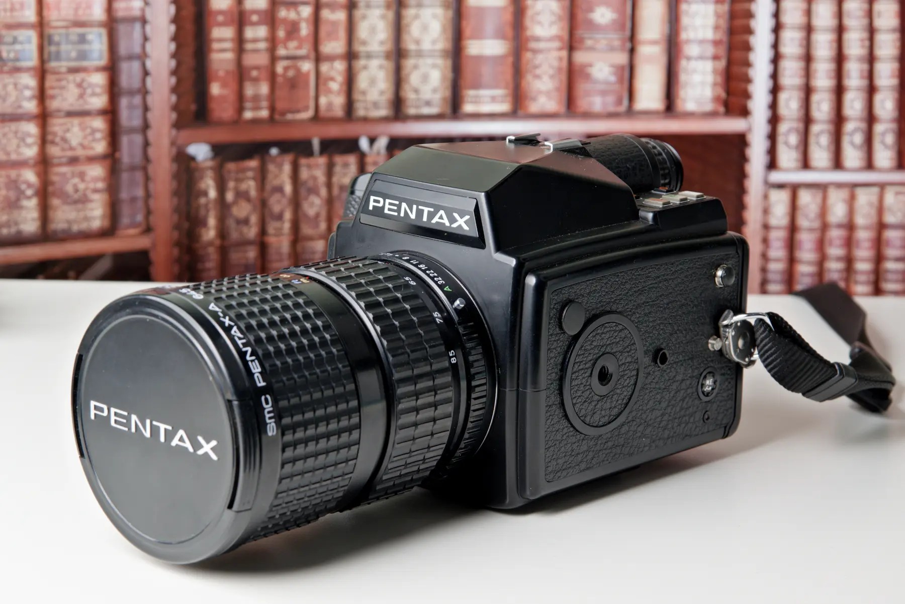 A Pentax 645 viewed from the front-left side. This shows the side with a tripod mounting area for vertical orientation. 