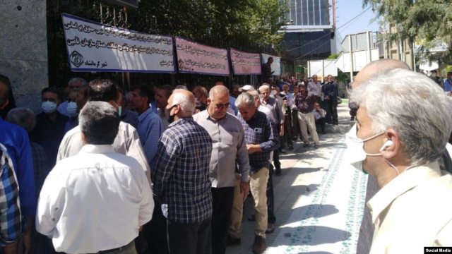 Pensioners of the Iranian Education Ministry, outside the Education Ministry in the western city of Kermanshah, spread an empty table to show that they cannot buy anything to eat.