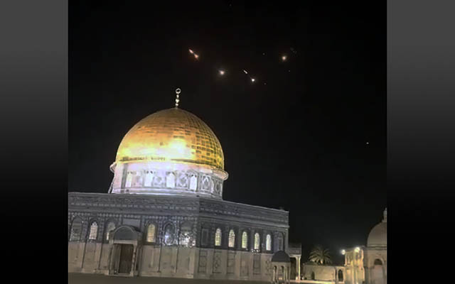 The Dome of the Rock with the lights of missile interceptions visible in the night sky, early on April 14, 2024