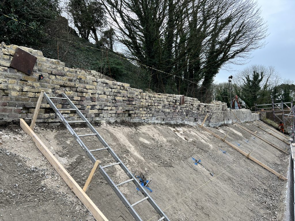 historic fort wall having monitoring positions installed with ongoing repair work