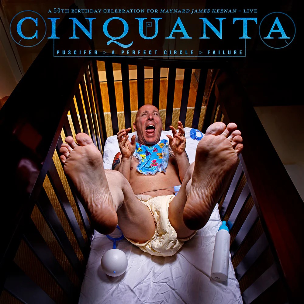 Cinquanta live cover art: adult man in diaper and bib in a crib, comedic theme for Maynard James Keenan’s 50th.