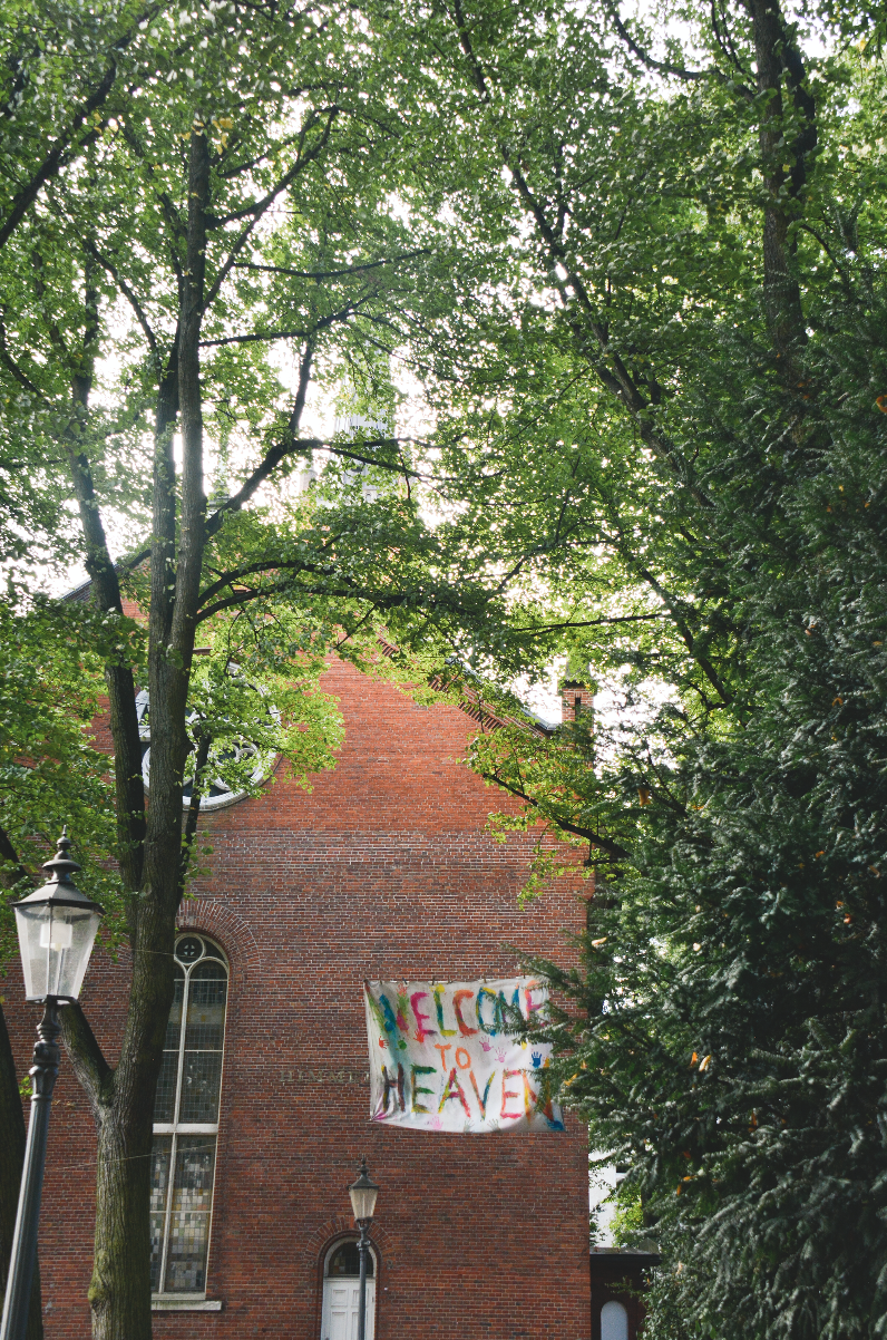 A church in Hamburg with a sign that reads "Welcome to Heaven." The church is significant because the pastor once sheltered a group of refugees there.